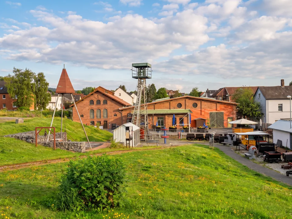 Der Zechenpark am Besucherbergwerk Klosterstollen in Barsinghausen mit Förderturm, Backsteinhallen und Grubenwagen