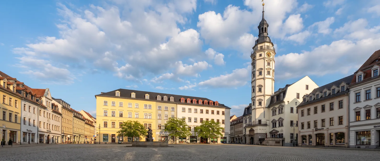 Der Markt in Gera mit dem weißen Renaissance-Rathaus und seinem schlanken Turm vor blauem Himmel
