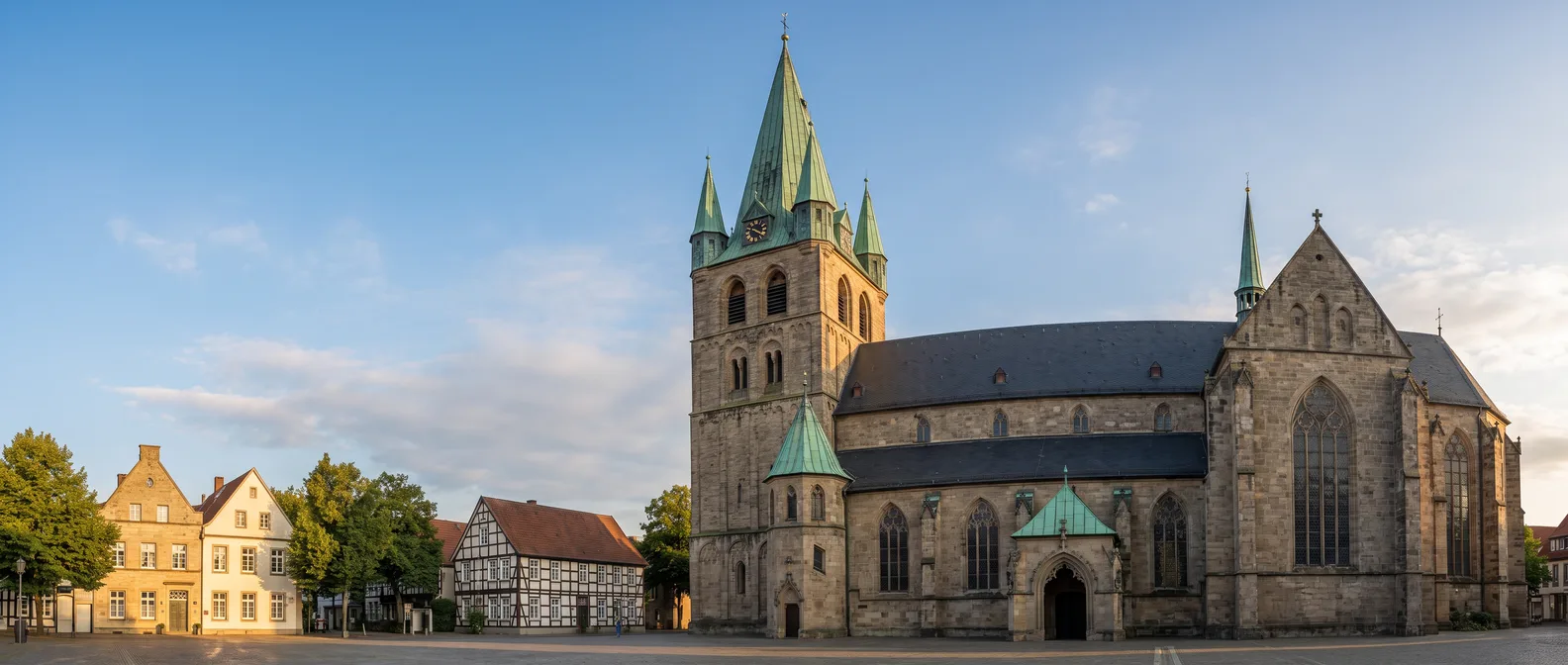 Die gotische Sandsteinkirche St. Laurentius in Warendorf mit grünem Kupferhelm und Ecktürmchen am Rand der Altstadt